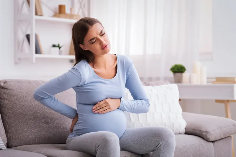 mujer con dolor de espalda durante el embarazo IAC